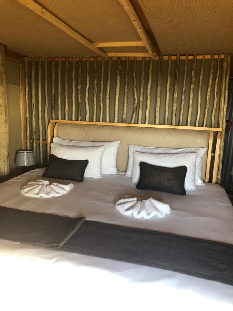 A chalet made up with twin beds and folded towels