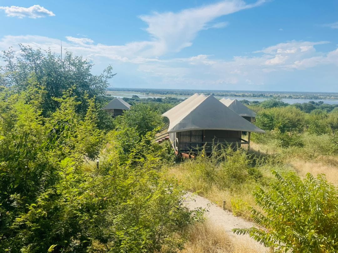 Tented chalets on the Xhabe plateau with the Chobe floodplain and river stretching out beyond