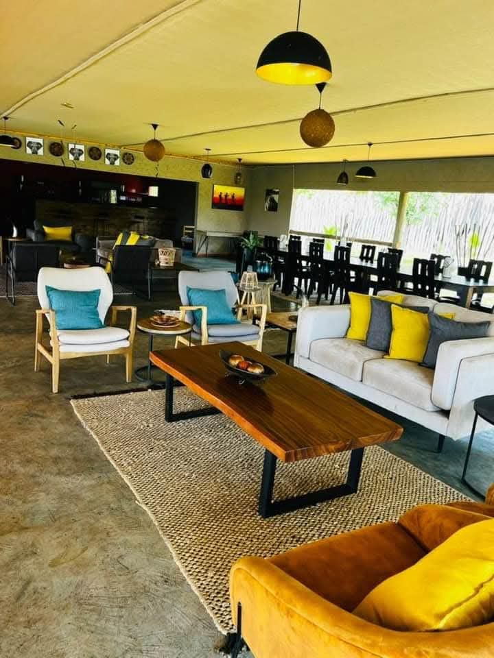 The lounge and bar area at Xhabe Safari Lodge, with the bar counter behind the seating