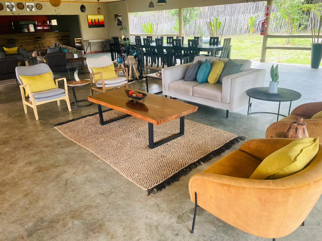 The lounge and dining area, with sofas, a live-edge coffee table and long dining tables beyond